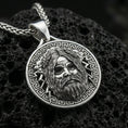 Load image into Gallery viewer, Polished silver Zeus necklace pendant on black volcanic stone background, crisp Zeus face relief and Greek key border, high-end product shot