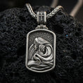 Load image into Gallery viewer, Oxidized Virgin Mary and Baby Jesus pendant on textured volcanic rock, macro close-up, Christian relief detail, premium studio lighting