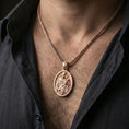Load image into Gallery viewer, Rose gold plated Saint Joseph pendant necklace worn on neck, lifestyle composition with dark clothing, crisp oval medallion silhouette
