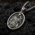 Load image into Gallery viewer, Oxidized Saint Joseph medal pendant on textured volcanic rock, macro close-up, Christian relief with child detail, premium studio lighting