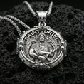 Load image into Gallery viewer, Polished silver Saint Uriel necklace pendant on black volcanic stone background, crisp angel wings and sword relief, high-end product shot