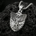 Load image into Gallery viewer, Polished silver Archangel Michael necklace pendant on black volcanic stone background, crisp shield border and angel figure, high-end product shot
