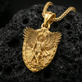 Load image into Gallery viewer, Gold plated Archangel Michael shield pendant displayed on porous volcanic rock surface, close-up studio composition, sharp engraved details and bail