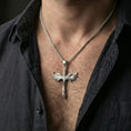 Load image into Gallery viewer, Polished silver Archangel Michael sword pendant on chain worn on neck, natural lifestyle framing, wings and blade clearly visible
