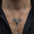Load image into Gallery viewer, Oxidized Archangel Michael pendant necklace worn on neck, lifestyle close-up on dark outfit, angel figure centered with wings visible