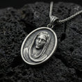 Load image into Gallery viewer, Oxidized Veiled Madonna pendant on textured volcanic rock, macro close-up, serene Virgin Mary relief detail, premium studio lighting