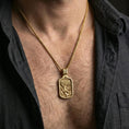 Load image into Gallery viewer, Gold plated Archangel Michael dog tag necklace pendant worn on neck, close-up lifestyle shot, luxury lighting with refined metallic highlights