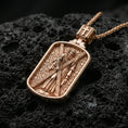 Load image into Gallery viewer, Rose gold plated Saint Andrew religious dogtag pendant on porous volcanic rock surface, macro product shot, clean silhouette and sharp relief