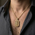 Load image into Gallery viewer, Gold plated Saint Andrew dog tag necklace pendant worn on neck, close-up lifestyle shot, refined metallic highlights and premium feel