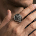 Load image into Gallery viewer, Oxidized octagon lion signet ring worn on finger, lifestyle close-up highlighting raised lion profile and ornamental side engravings