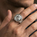 Load image into Gallery viewer, Polished silver octagon lion signet ring worn on finger, lifestyle hand shot showing crisp frame, textured background, and detailed mane depth