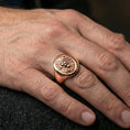 Load image into Gallery viewer, 925 sterling silver lion head signet ring worn on a finger, rose gold plated finish with warm tone and sculpted lion mane texture