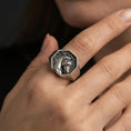 Load image into Gallery viewer, Oxidized horse signet ring worn on finger, lifestyle close-up showing the octagon face and engraved stallion head