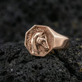 Load image into Gallery viewer, Rose gold plated horse signet ring on volcanic rock, crisp macro photo showcasing the octagonal top and detailed horse head relief
