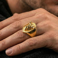 Load image into Gallery viewer, Gold plated bull signet ring worn on finger, lifestyle wear shot emphasizing the bold animal portrait and textured background