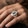 Load image into Gallery viewer, Polished silver bull ring on finger, natural hand pose highlighting the sculpted head and clean oval bezel
