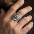 Load image into Gallery viewer, Oxidized owl ring worn on finger, lifestyle close-up focusing on the outstretched wings and detailed feather engraving