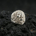 Load image into Gallery viewer, Polished silver lion ring on volcanic rock surface, close-up highlighting the layered mane texture, defined whisker pads, and clean ring profile