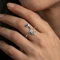 Load image into Gallery viewer, Polished silver cobra ring on finger, natural hand pose highlighting the hooded snake silhouette and engraved scale pattern