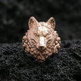 Load image into Gallery viewer, Rose gold plated wolf head ring on rugged volcanic rock surface, high-end studio macro composition