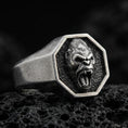 Load image into Gallery viewer, Close-up of an oxidized sterling silver octagon gorilla signet ring on porous volcanic rock in a dark studio shot