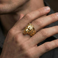 Load image into Gallery viewer, Gold plated lioness ring worn on a finger with dark minimal background, focusing on the powerful feline profile