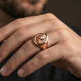 Load image into Gallery viewer, Rose gold plated lion signet ring on finger, close-up lifestyle photo showing the lion head relief, bezel edge, and premium shine