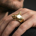 Load image into Gallery viewer, Gold plated shark ring worn on a finger with dark minimal background, emphasizing the statement silhouette
