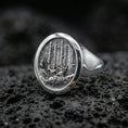 Load image into Gallery viewer, Polished silver nature signet ring on textured volcanic stone, macro focus on the woodland engraving