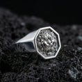 Load image into Gallery viewer, Octagon sterling silver Foo Dog signet ring in polished silver finish on volcanic rock, detailed guardian lion carving, close-up photo