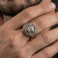 Load image into Gallery viewer, Octagon sterling silver Foo Dog signet ring in an oxidized finish worn on finger, Chinese guardian lion relief visible, lifestyle hand close-up