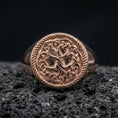 Load image into Gallery viewer, Yggdrasil ring in a rose gold plated finish on volcanic rock, ornate Norse Tree of Life knot pattern, luxury studio close-up
