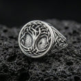 Load image into Gallery viewer, Sterling silver Tree of Life signet ring in polished silver finish on volcanic rock, Celtic knot details with textured background, close-up photo