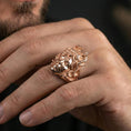 Load image into Gallery viewer, Medusa ring in a rose gold plated finish on finger, detailed gorgon portrait with coiled snakes, lifestyle wear photo