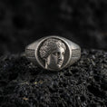 Load image into Gallery viewer, Sterling silver Venus goddess signet ring in an oxidized finish on volcanic rock, Roman profile portrait with Greek key sides, macro jewelry shot