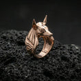 Load image into Gallery viewer, Anubis jackal head ring in a rose gold plated finish on volcanic rock, minimalist Egyptian mythology form with symbolic side motif, high-end close-up
