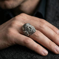 Load image into Gallery viewer, Oxidized Hephaestus signet ring worn on finger, masculine mythology ring with sculpted forge god portrait and rugged depth