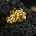 Load image into Gallery viewer, Gold plated Minotaur signet ring with high-relief axe warrior beast and sculpted anatomy, premium studio macro on black volcanic rock surface