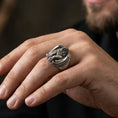 Load image into Gallery viewer, Oxidized sterling silver griffin guardian ring worn on finger, protective mythical beast design symbolizing strength and guidance, masculine lifestyle hand shot