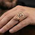 Load image into Gallery viewer, Rose gold plated Zeus ring on finger featuring ornate god face relief, refined men’s jewelry lifestyle wear shot