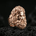 Load image into Gallery viewer, Rose gold plated Zeus ring showcasing expressive god face sculpture and rich texture, sharp close-up product photography on volcanic rock