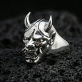 Load image into Gallery viewer, Polished sterling silver Oni mask signet ring on black volcanic stone, detailed menacing Hannya/Oni face, sharp teeth and horned helmet