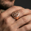 Load image into Gallery viewer, Rose gold plated samurai warrior ring on a human finger, engraved samurai face signet, dramatic Japanese-inspired design