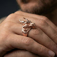 Load image into Gallery viewer, Rose gold plated horned dragon ring on a human finger, horned dragon design with scale texture, statement accessory