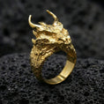 Load image into Gallery viewer, Gold plated horned dragon ring on black volcanic stone, intricate dragon scales and horns, bold mythic jewelry