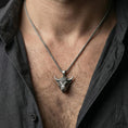 Load image into Gallery viewer, Oxidized sterling silver bull head necklace pendant worn on a human neck, Taurus zodiac horned bull charm, braided chain