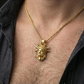 Load image into Gallery viewer, Gold plated Statue of Liberty pendant worn on a human neck, NYC souvenir charm, braided chain necklace