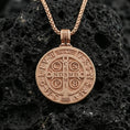 Load image into Gallery viewer, Rose gold plated St. Benedict medal necklace on black volcanic stone, Catholic faith protection pendant, braided chain