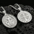 Load image into Gallery viewer, Polished sterling silver St. Benedict medal necklace on black volcanic stone, sacred Christian devotional pendant, braided chain