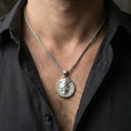 Load image into Gallery viewer, Polished silver memento mori medallion necklace worn on neck, close lifestyle crop, crisp engraving and relief visibility